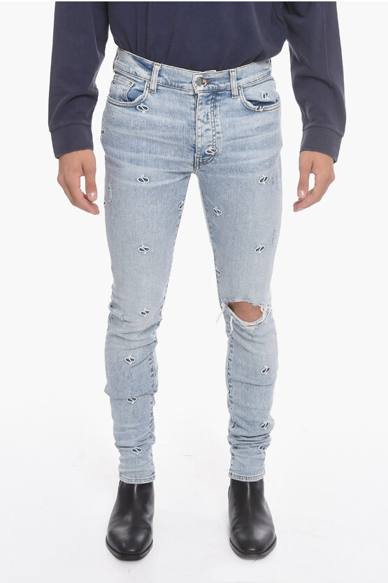 Amiri Skinny-fit Logo-appliquéd Crystal-embellished Distressed Jeans In Bleached Indigo