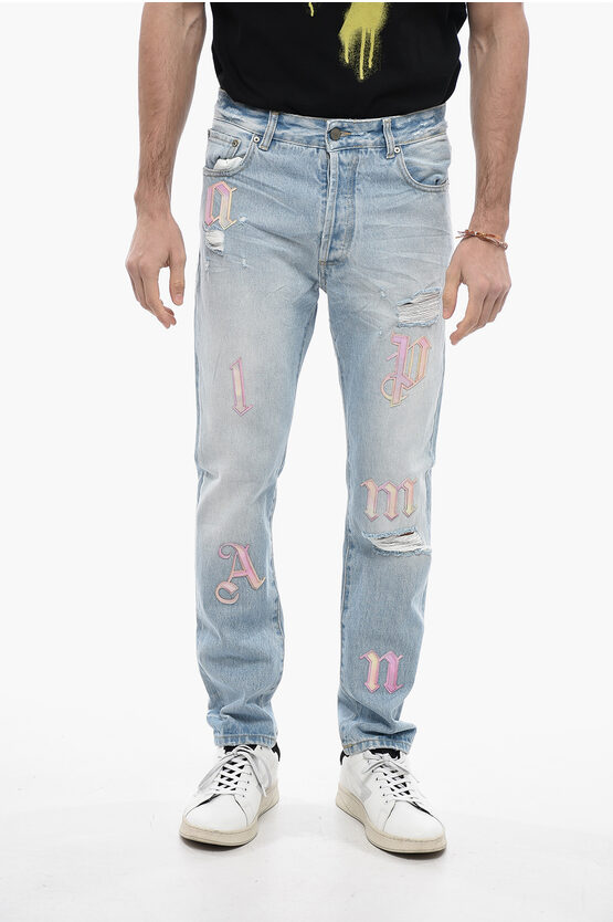 Palm Angels Light Washed Distressed Jeans With Patches In Blue