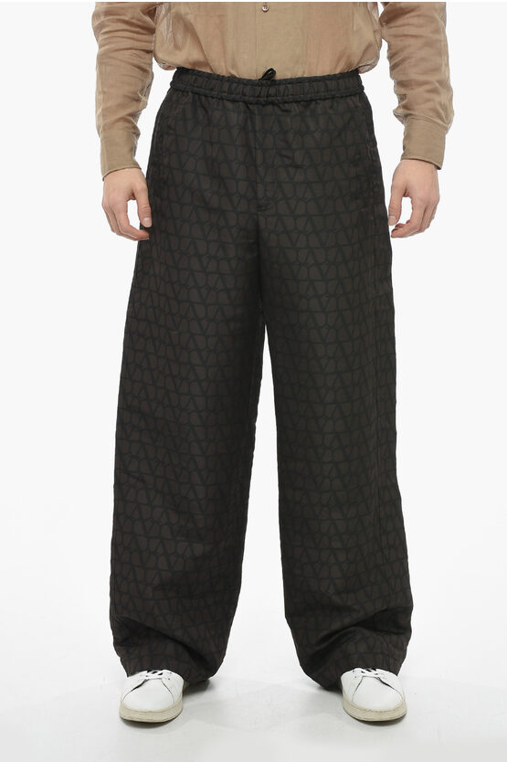Valentino Silk Joggers With All Over Logoed Pattern In Black